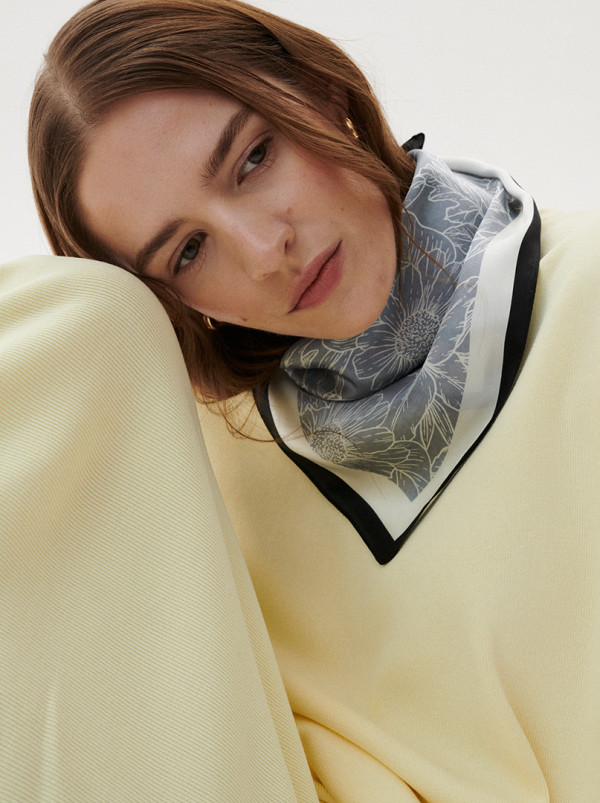 Silk gavroche on grey-blue background with a sophisticated design 53 cm x 53 cm